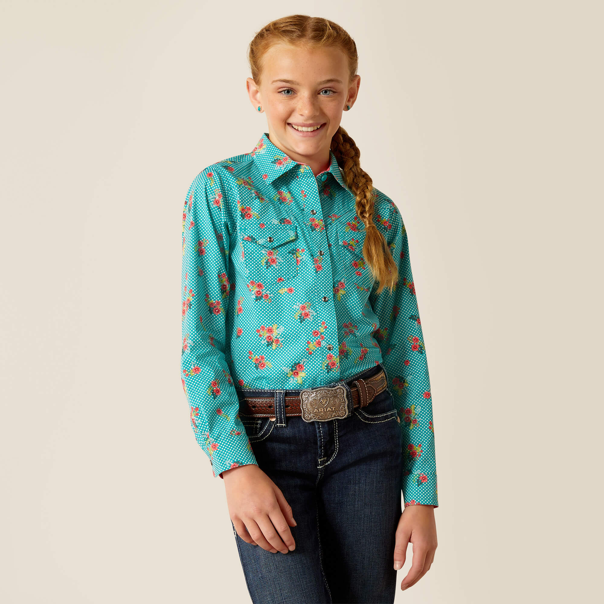 Girl's Ariat long sleeve western style shirt in a dotted Green with a floral print. Front view showing shirt tucked in.