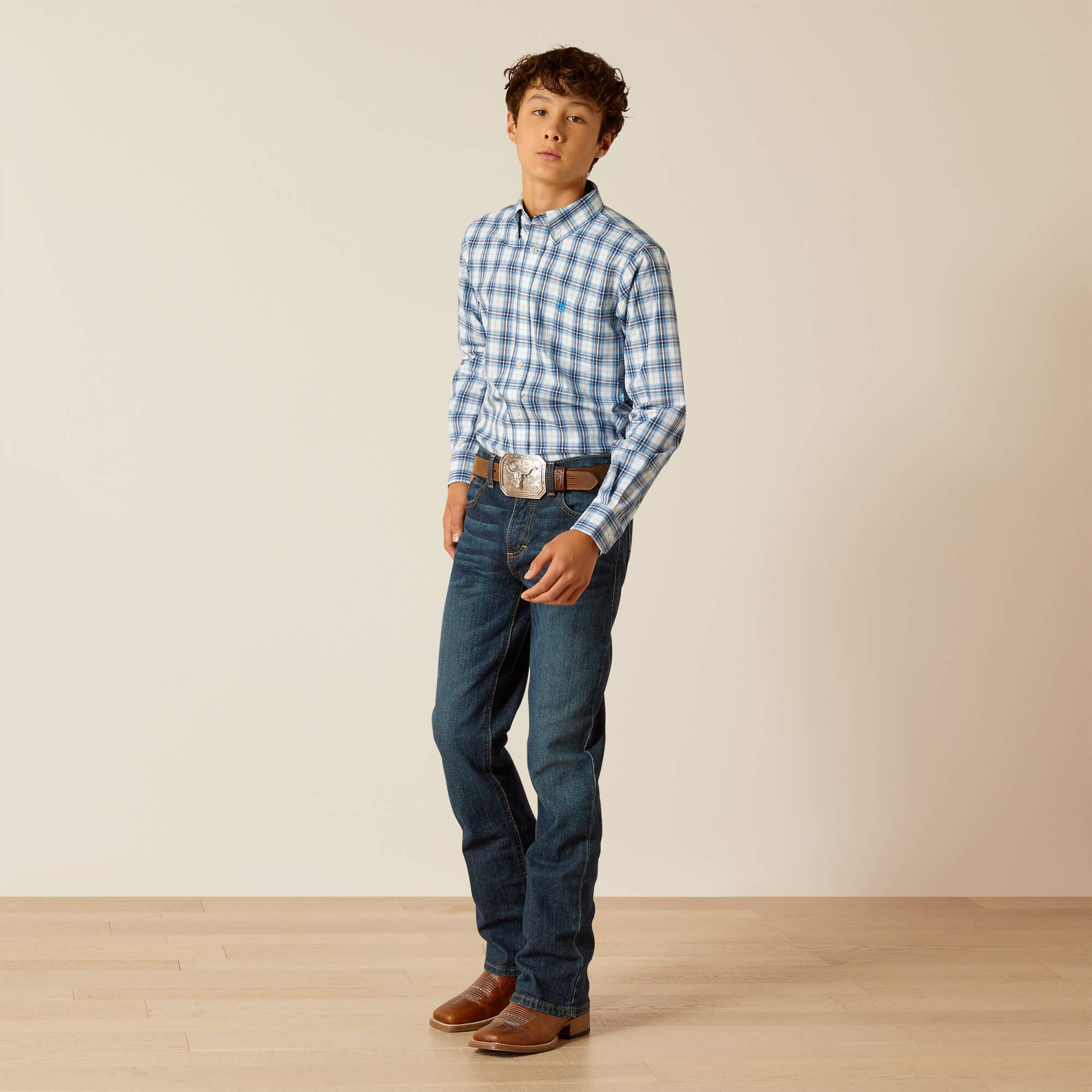 Boy's Ariat long sleeve Pro Series shirt in Blue Plaid. Side view showing shirt tucked in.