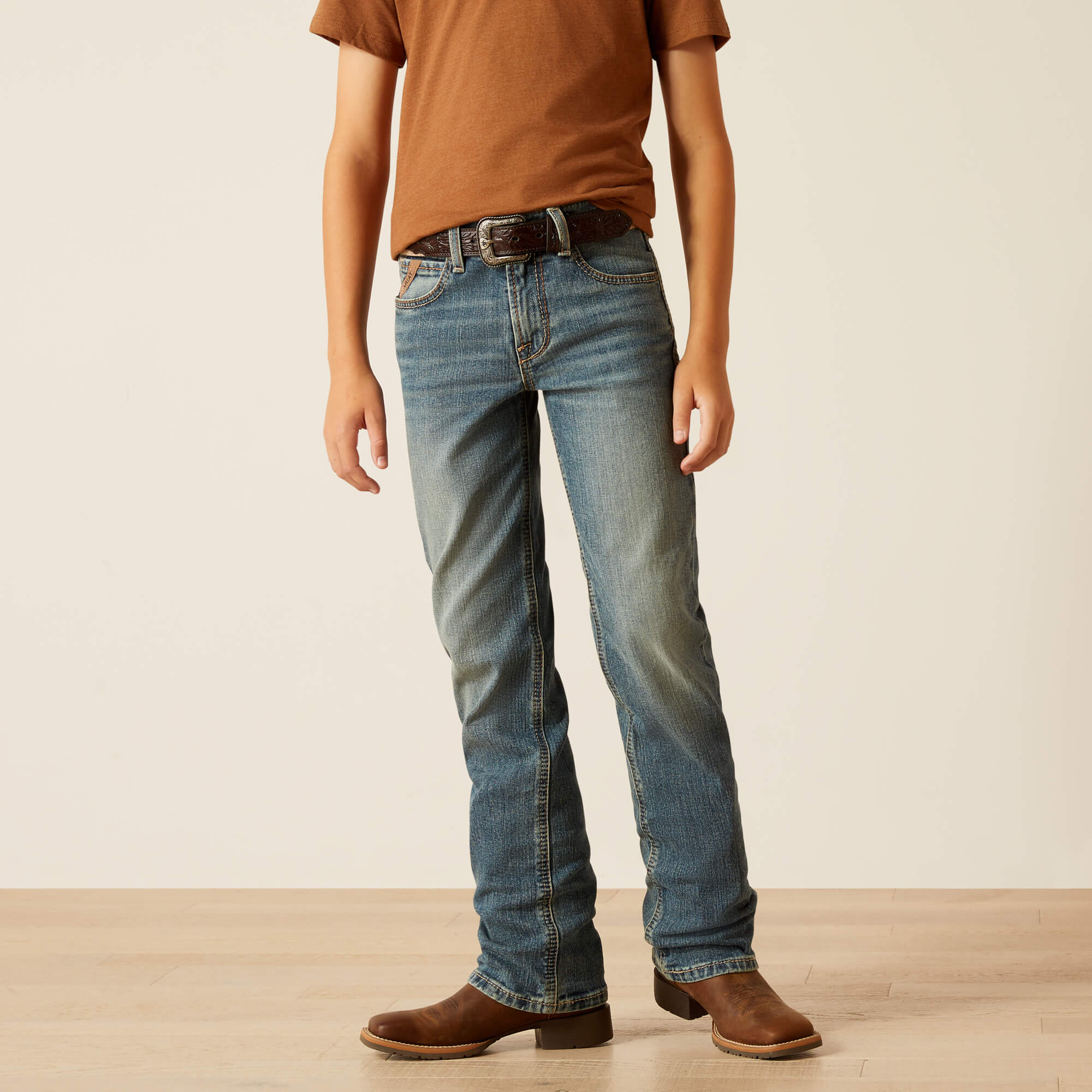 Boy's Ariat B5 slim straight jean in a medium wash. Front view