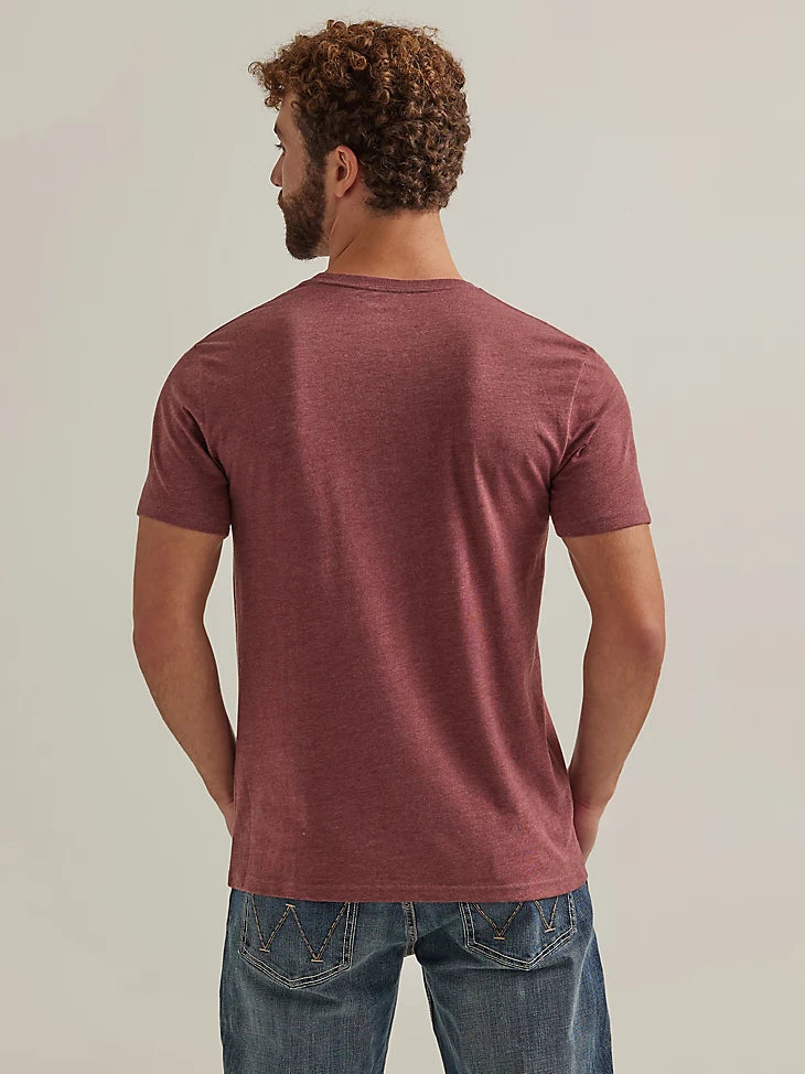 A man wearing a short sleeve, crew neck Wrangler George Strait t-shirt in port color. Back view.