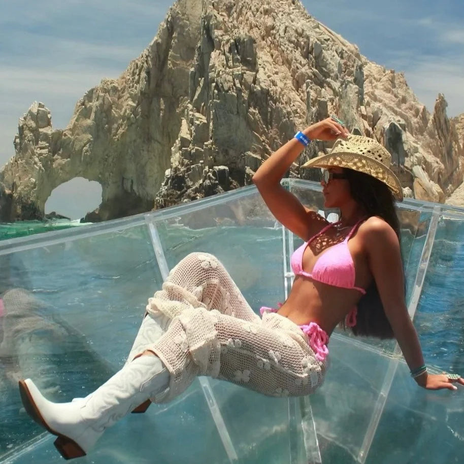 A life style photo of a women wearing a pair of white smooth leather women's Dingo boot with a snip toe and a western heel.