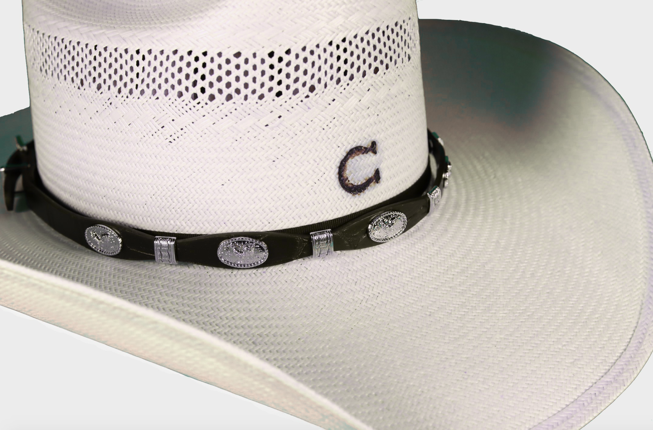 Black leather had band with Rooster Conchos separated by Silver bands. Shown on a straw hat.