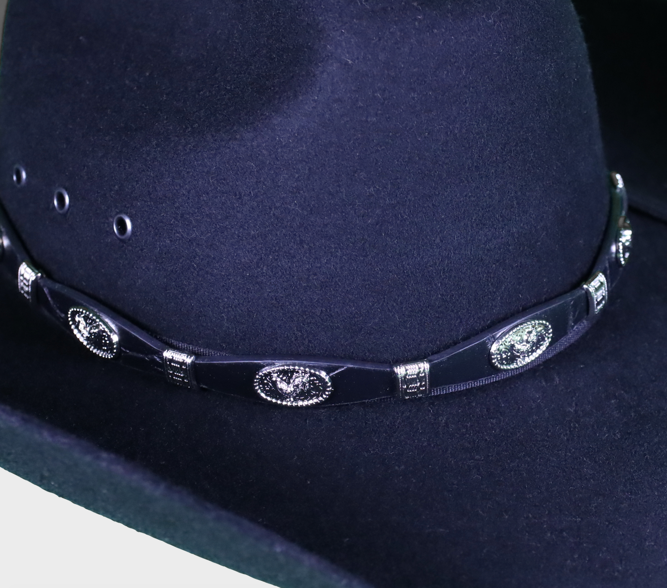 Black leather had band with Rooster Conchos separated by Silver bands. Shown on a Black felt hat.