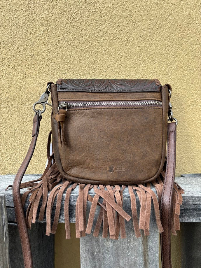 This Coffee Brown tooled leather crossbody bag has fringe sides. It has a removable and adjustable shoulder strap. It has a embossed leather front flap and a zippered closed back pocket. Rear View
