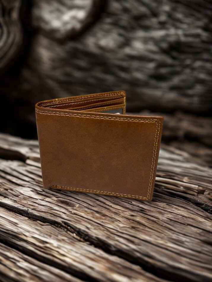 Brown leather wallet on a wooden surface with a blurred natural background