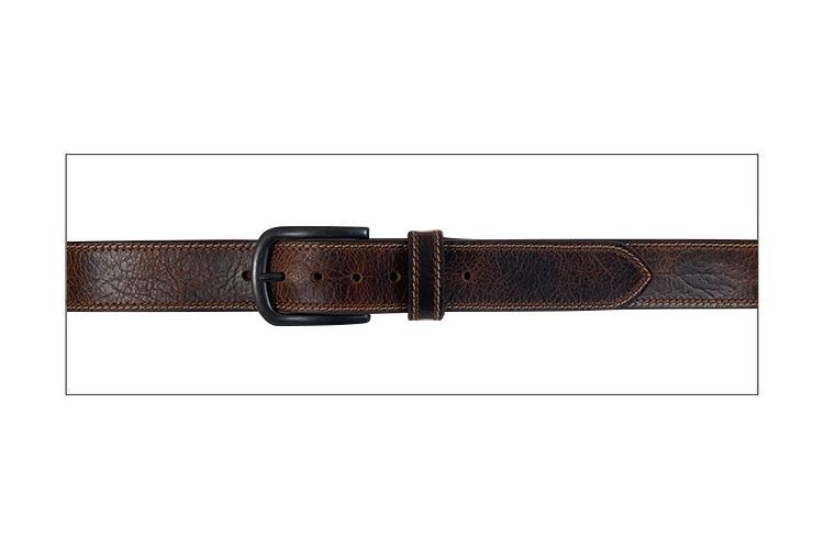 A flat view of a tan and brown distressed leather belt with a removable antique brass buckle.