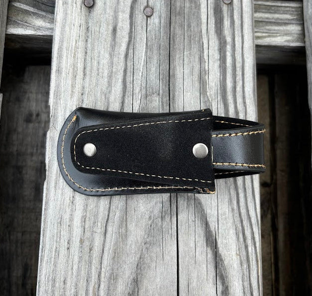 This Black leather knife sheath by Top Notch Accessories features a embossed Praying Cowboy design and has a keep for closure. Rear view showing leather belt loop.