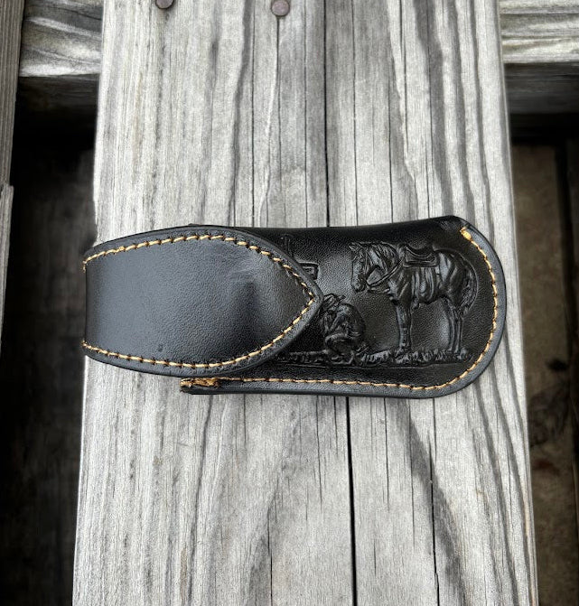 This Black leather knife sheath by Top Notch Accessories features a embossed Praying Cowboy design and has a keep for closure. Front View