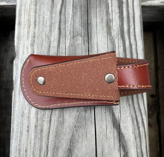 This Brown leather knife sheath with a Praying Cowboy design features a keep closure. Rear view showing the leather belt attachment.