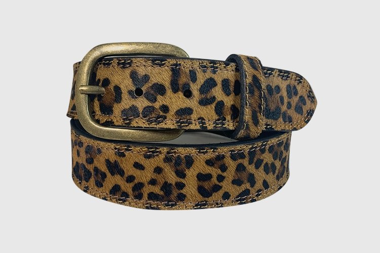 A brown leopard print hair-on leather belt with a brass oval buckle.