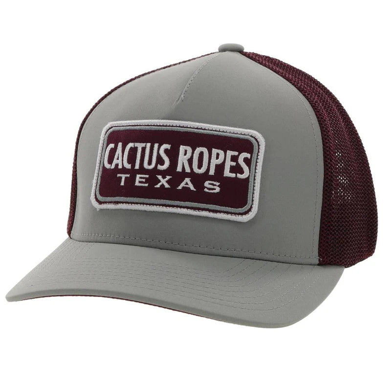 Hooey Gray and maroon trucker hat with 'Cactus Ropes Texas' patch. Front view stock photo.