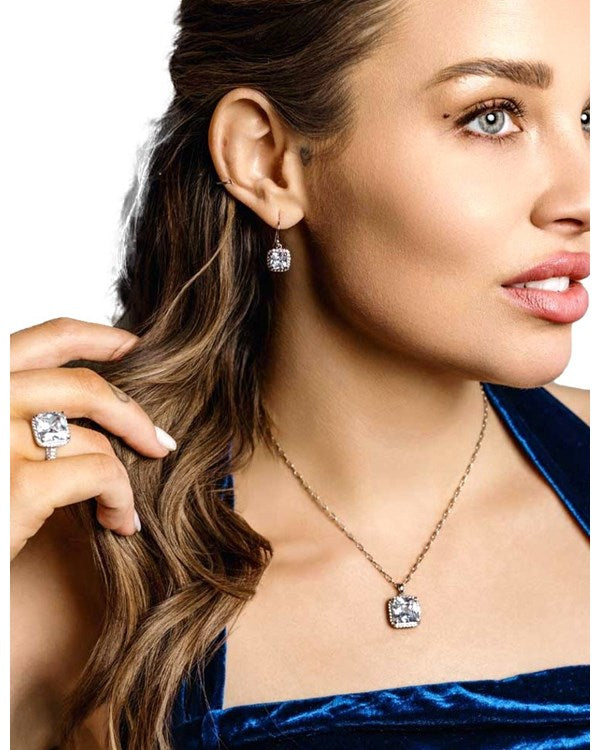 Earrings featuring cubic zirconia center stone with a French wire hook. Shown on model