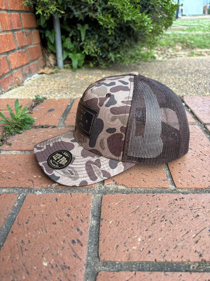 Zep-Pro rectangle leather patch with Oxford, Mississippi Established 1817 on an old school brown camo Richardson 112PFP cap. Cap features a brown mesh back and is adjustable. Side View