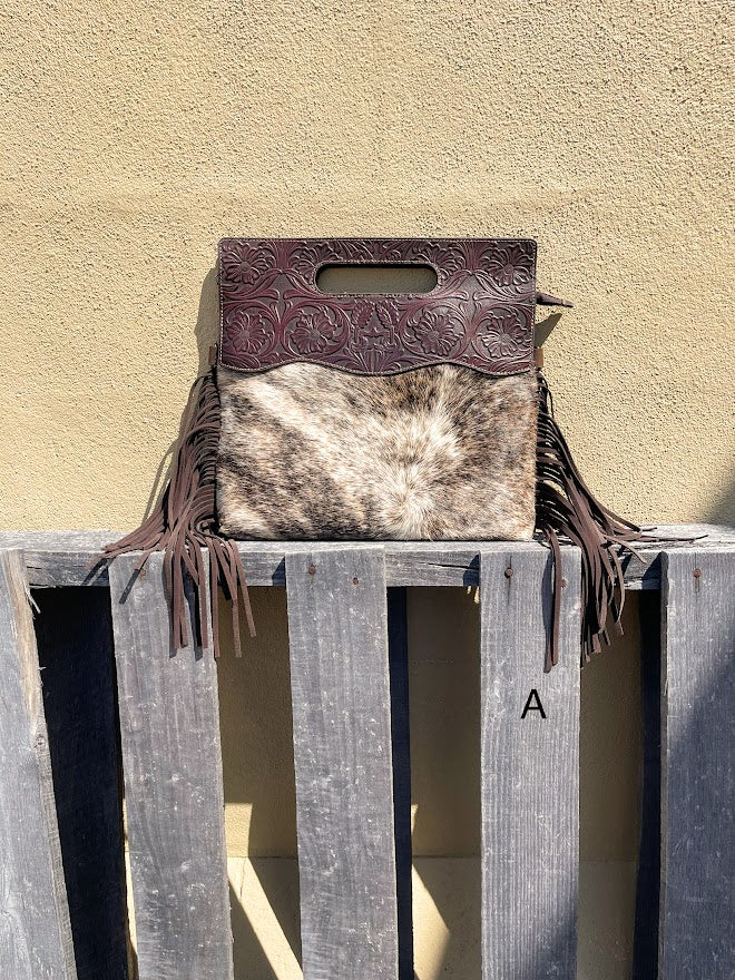 Cowhide and Coffee Brown tooled leather purse with fringe. This bag can be carried by the handle or the removable, adjustable strap. Front View A