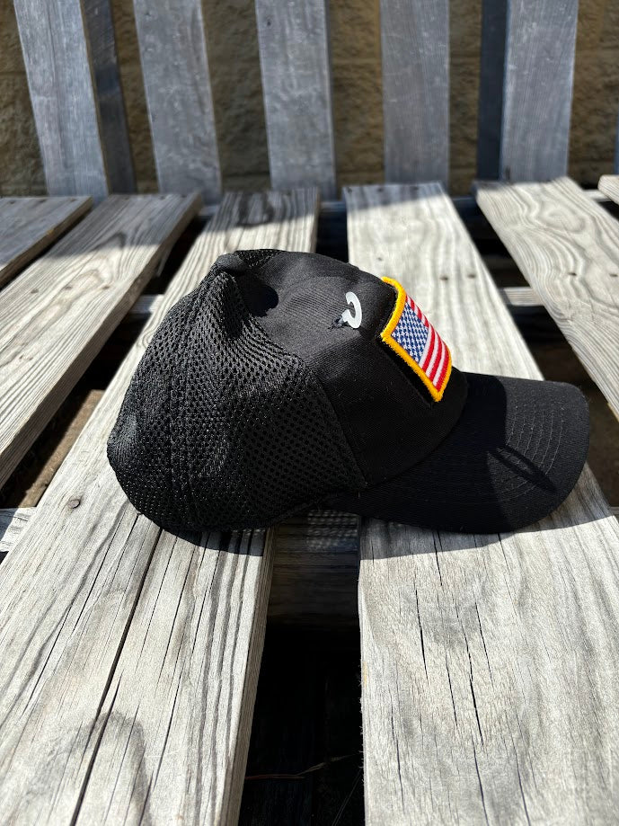 A Back mesh back cap with an American flag patch on the front. Side View