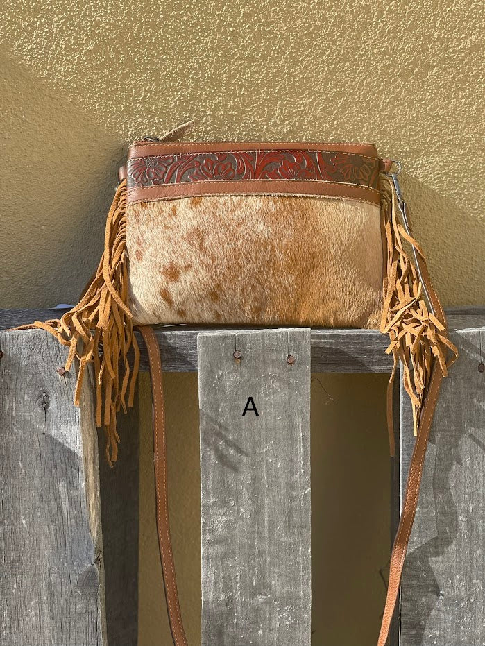 Brown leather and cowhide crossbody bag with side fringe. Front View A