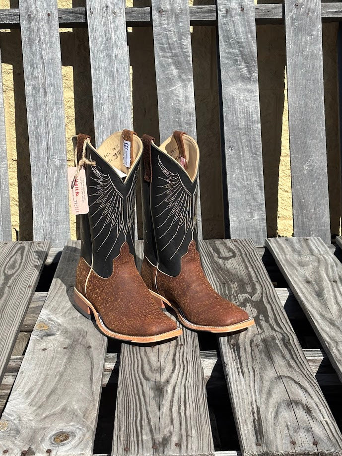 A pair of Men's Anderson Bean 12-inch tan hungry hippo skin boots with black waxy Kansas leather tops.