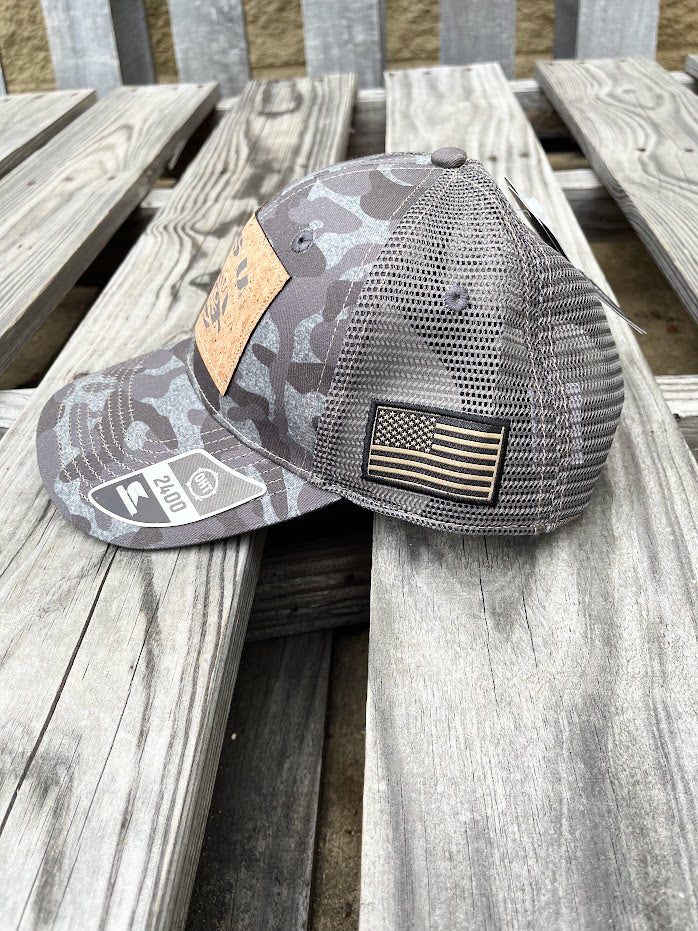 Colosseum Athletics Heather Camo snapback cap with a Louisiana State University "LSU" logo with a Tiger eye cork patch on the front. Side view showing American Flag patch.