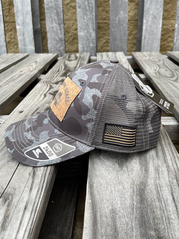 Colosseum Athletics Heather Camo snapback cap with a Mississippi State University logo cork patch on the front. Side view showing American Flag patch.