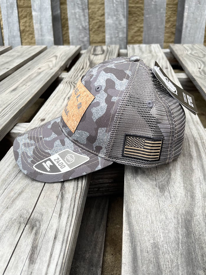 Colosseum Athletics Heather Camo snapback cap with a University of Mississippi "Ole Miss" Rebels logo cork patch on the front. Side view showing American Flag patch.