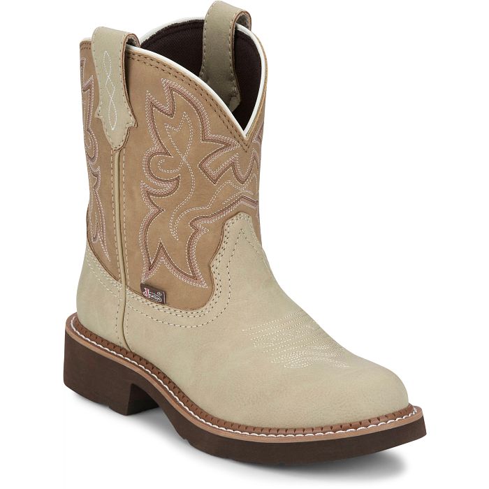 A profile view of a beige Justin Brand cowboy boot with brown accents on a white background.