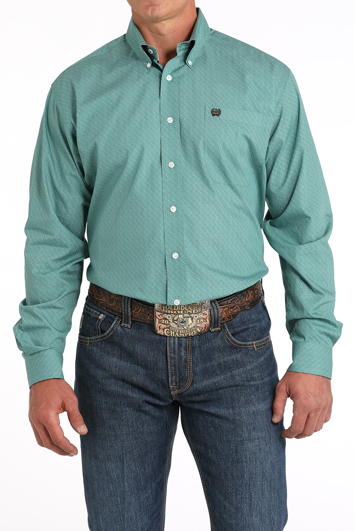 Teal green geometric print Cinch button-down long sleeve shirt and jeans with a belt and buckle on model. Front view.
