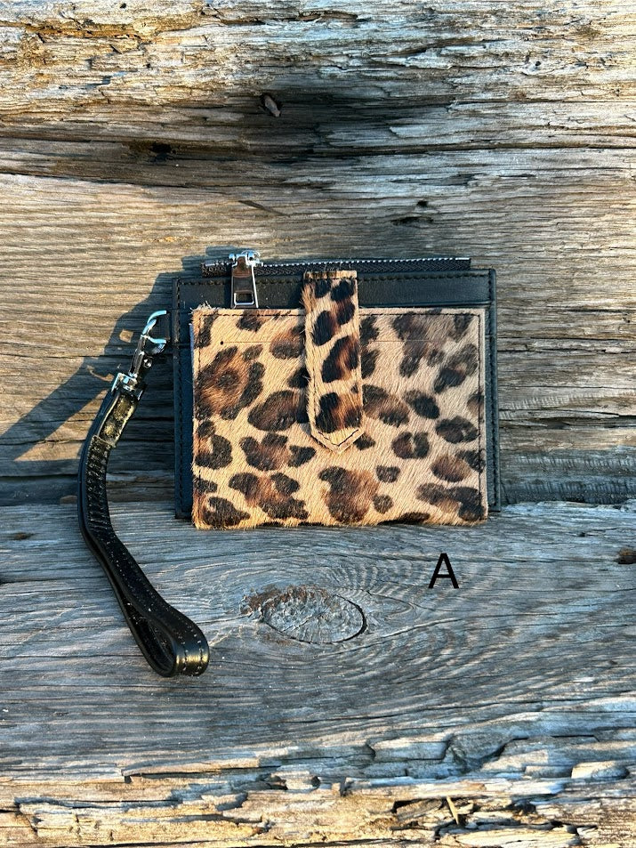 A leopard cowhide keychain wristlet wallet. A