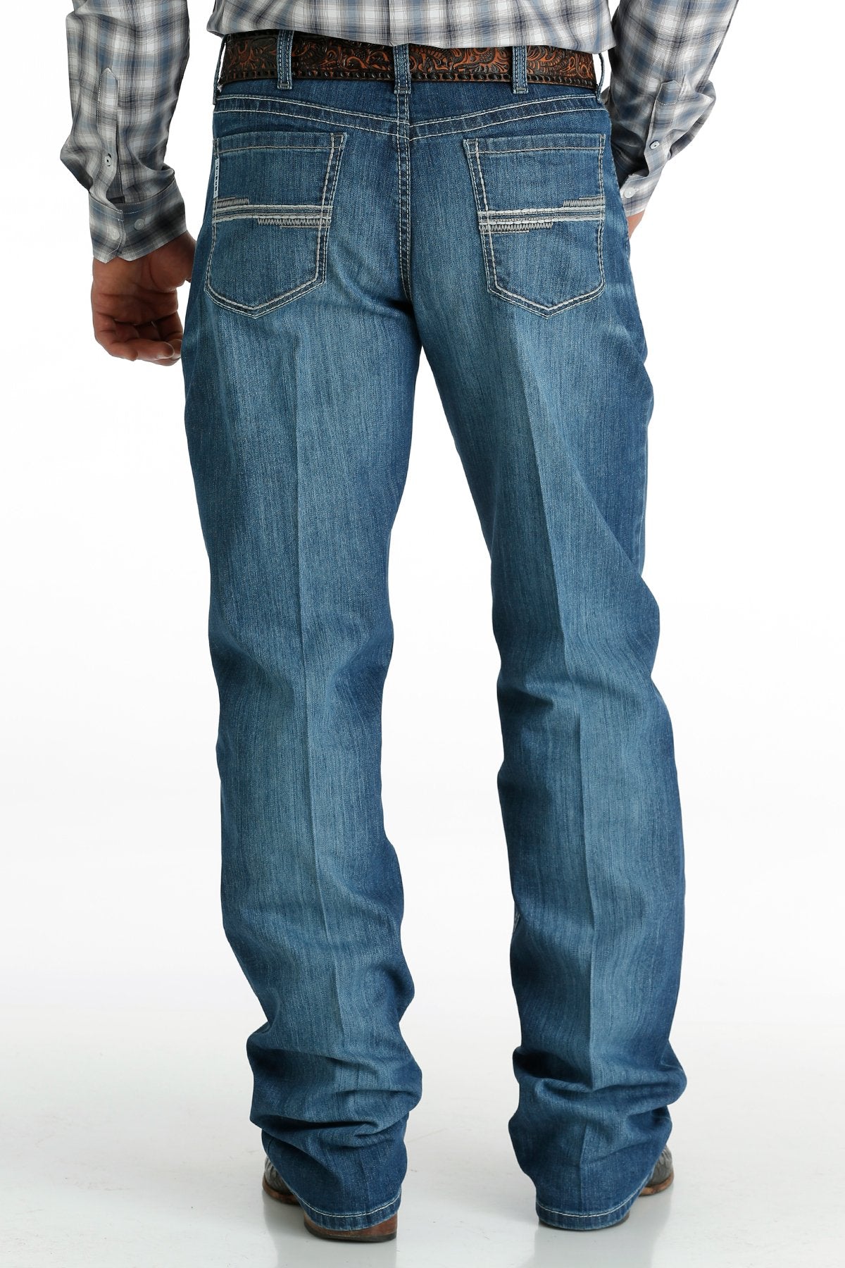 Men's White Label Medium Wash jeans back view showing detail of back pockets, belt loop placement, relaxed fit on seat and leg, stack on boots.
