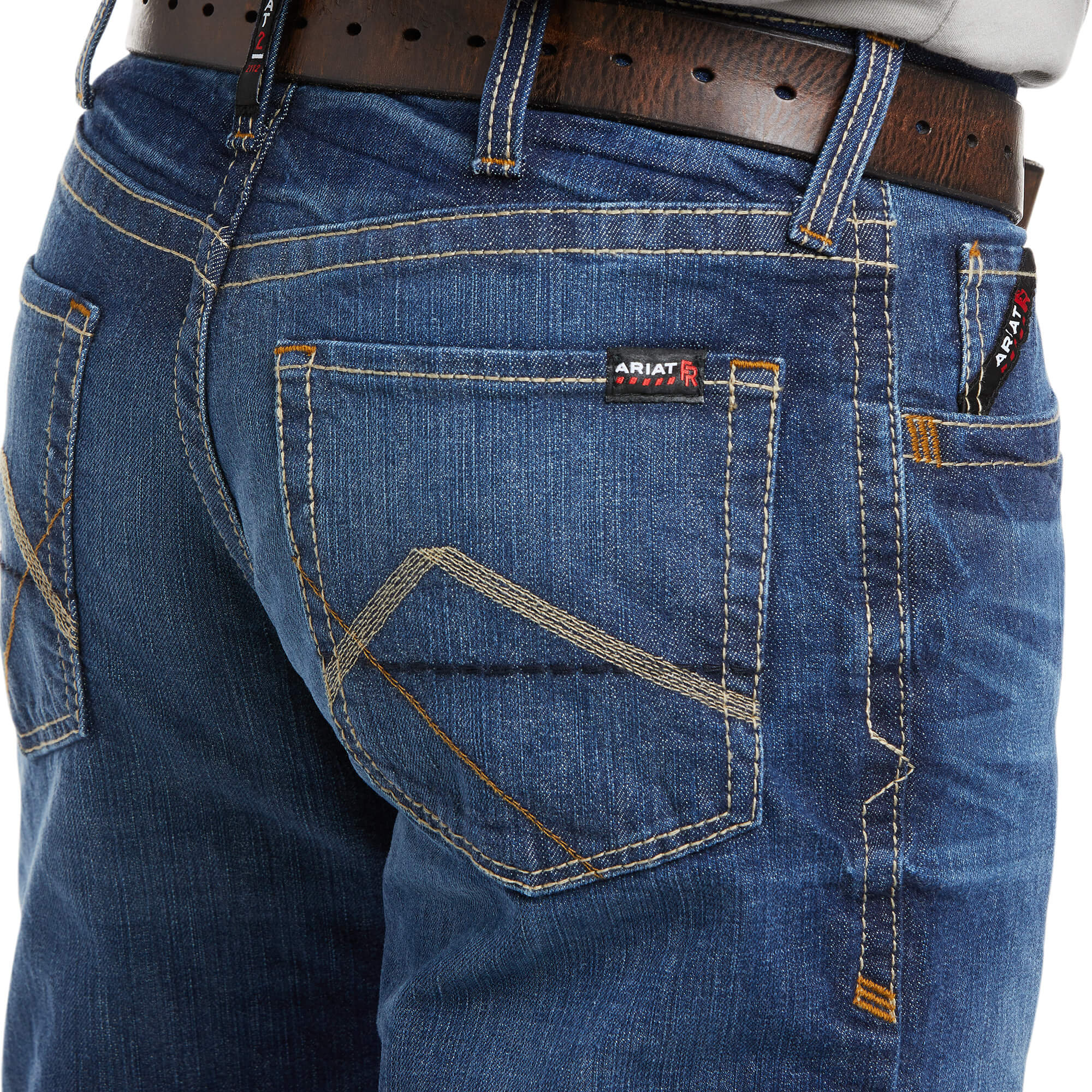 Men's Ariat FR boot cut jean in a M4 relaxed fit, this jean is a medium wash. Close up of back pocket details showing stitching and Ariat FR logo tag.