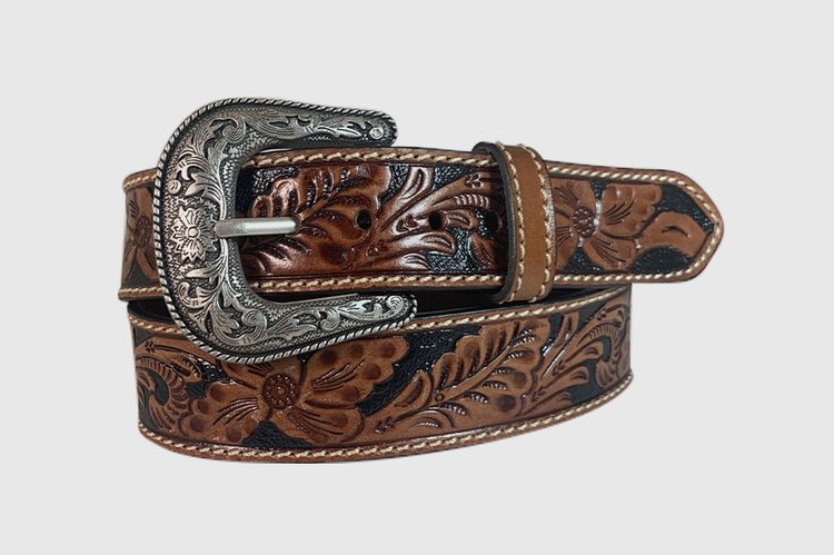 A brown floral hand tooled leather belt with a silver removable buckle.