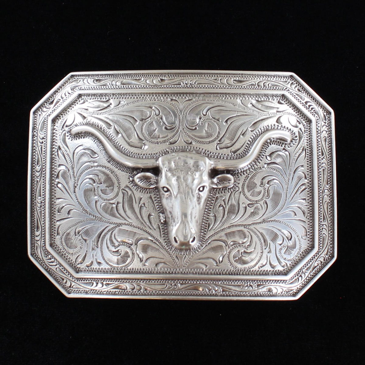 This is a silver tone rectangle buckle with a stylish smooth edge. It features a centered longhorn motif on a western scroll engraving.