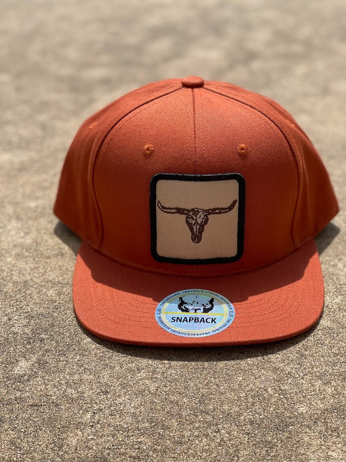 Rust snapback cap with a longhorn patch on the front. Front View