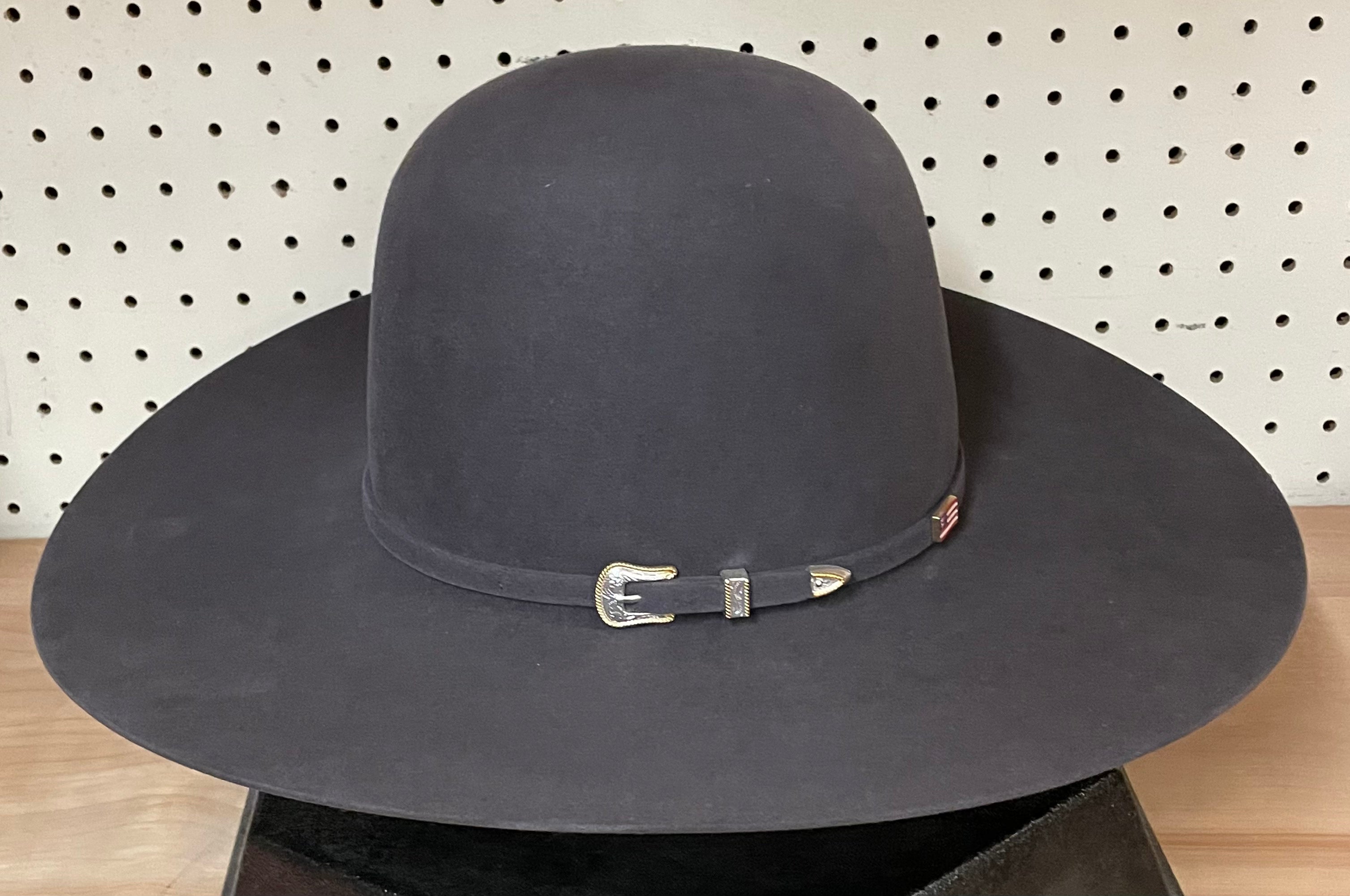 American Hat company open crown flat brim felt cowboy hat in Steel. Side view featuring buckle on hat band.