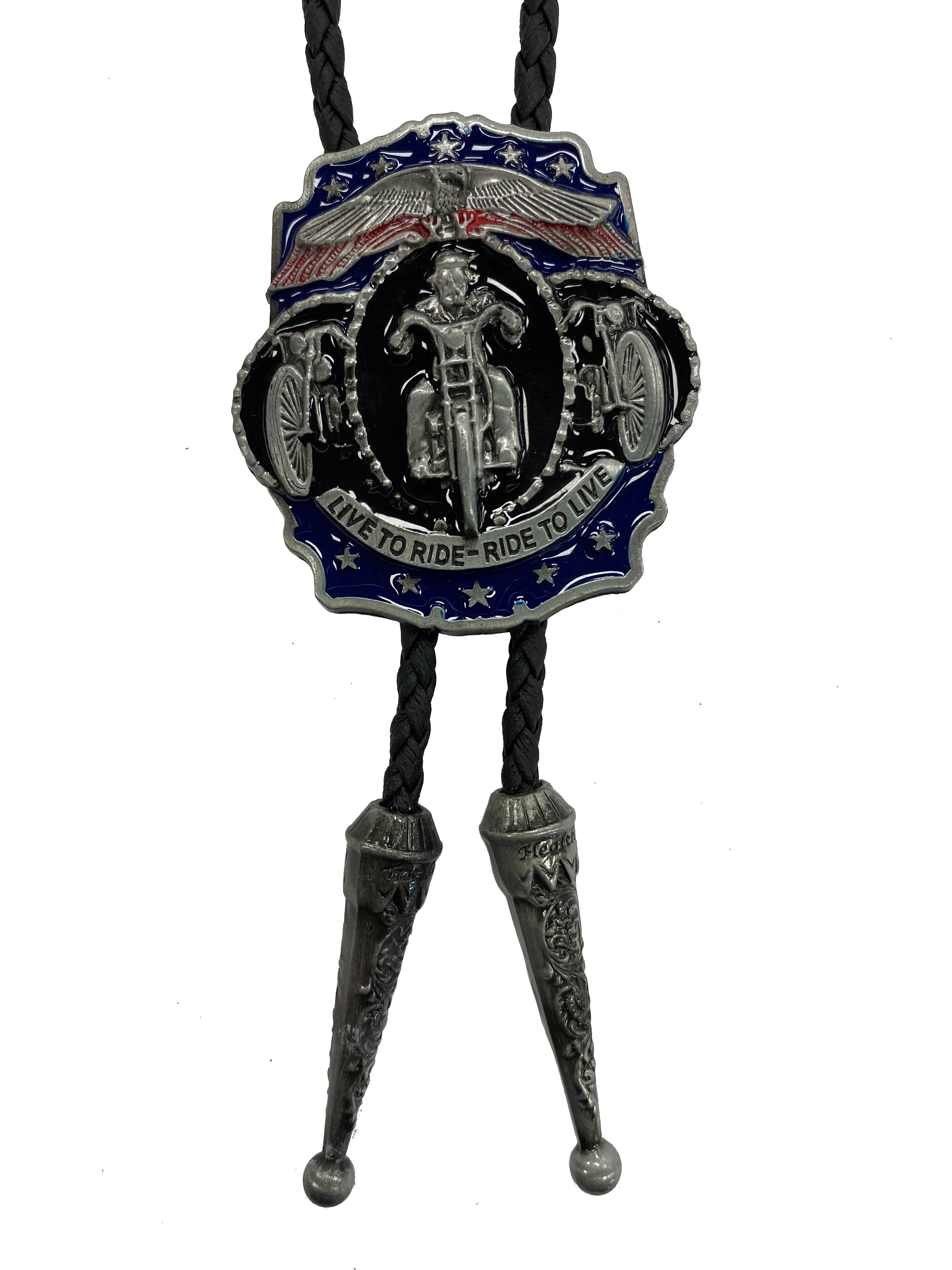 This bolo tie features a motorcycle with the lettering "Live to Ride Ride to Live". It is on a Black braided cord with metal tips.