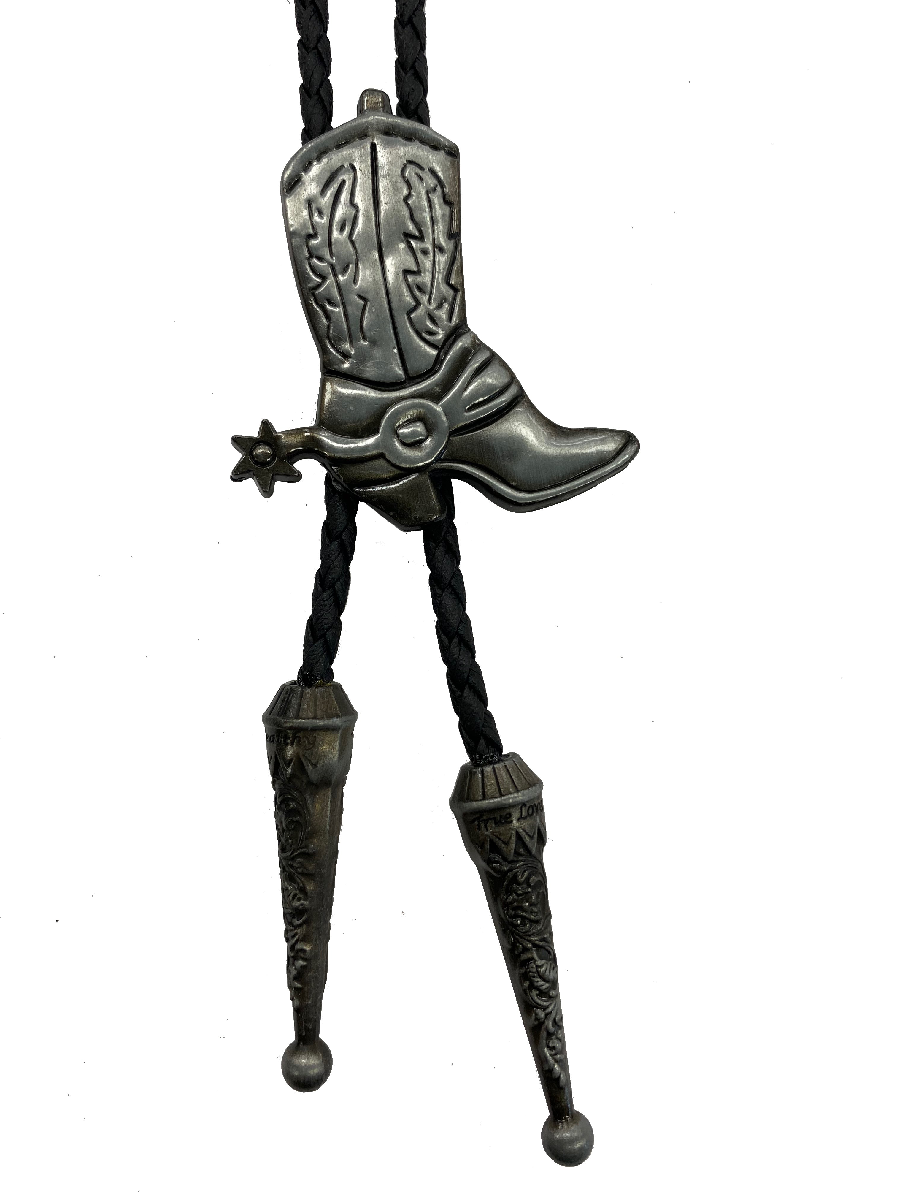 This boot shaped bolo tie features a spur and it is fully adjustable on a Black braided cord with metal tips.