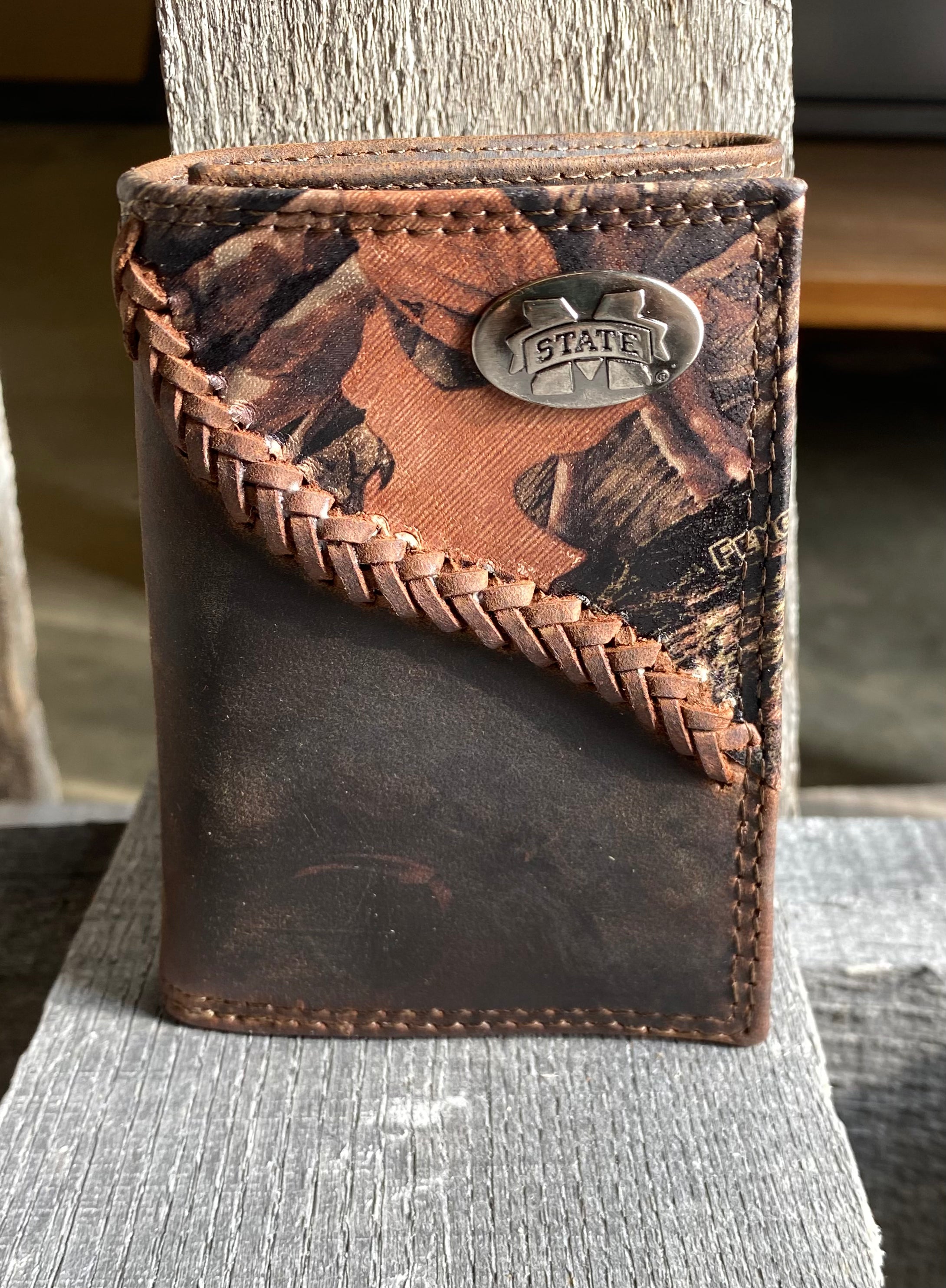 Zep-Pro Mississippi State University Bulldogs 1/2 Mossy Oak Camo/Brown Leather Trifold Wallet with a brass M State concho on top right corner of camo leather. Front view