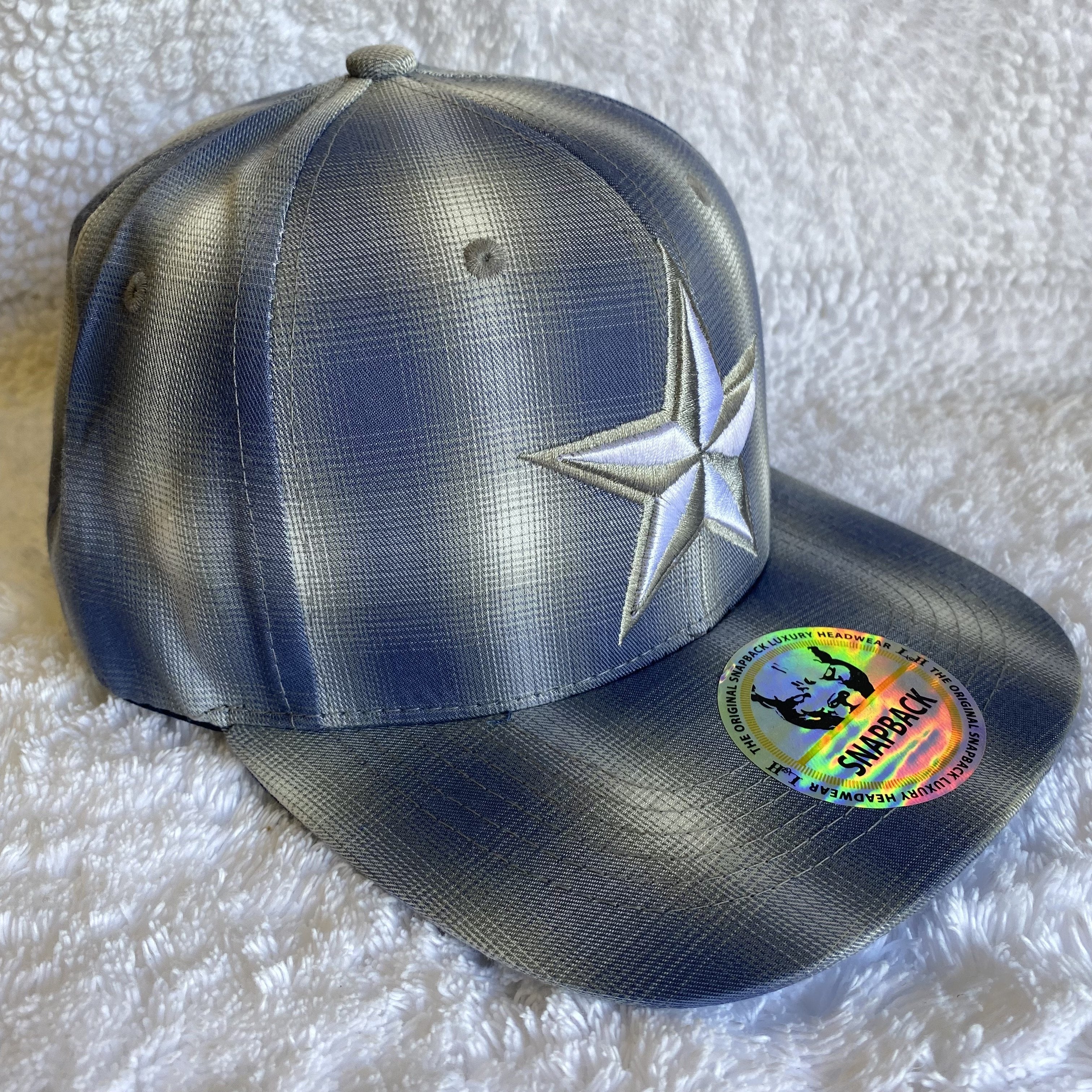 Blue plaid snapback cap with a embroidered star.
Side View