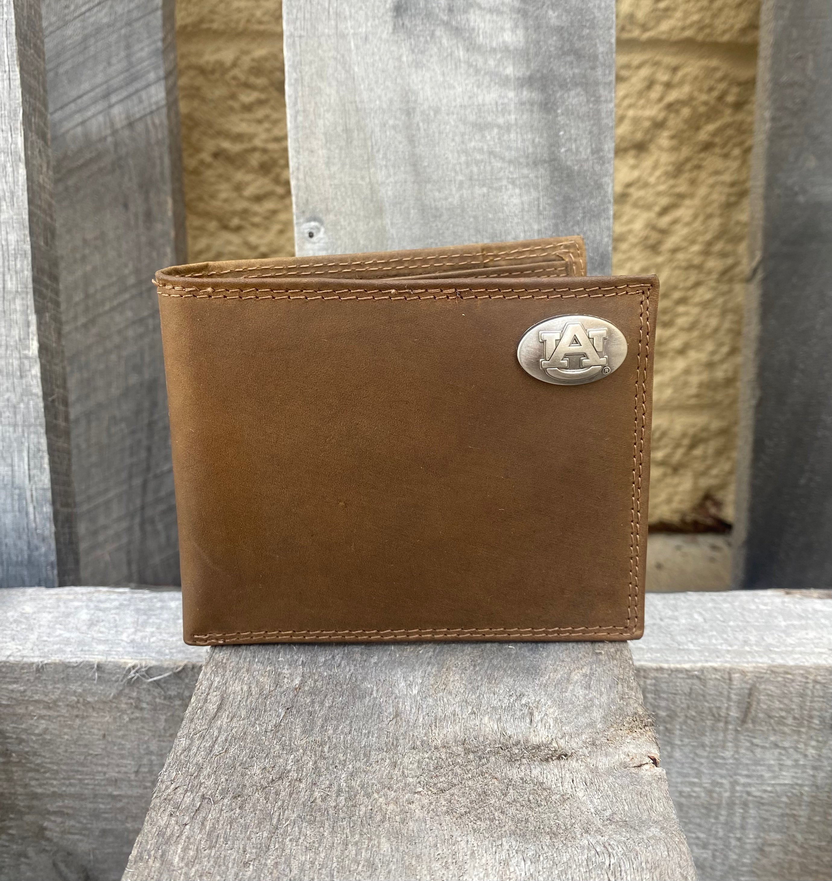 Zep-Pro Auburn University Brown “Crazy Horse” Leather Bifold Wallet.
with an "AU" logo brass concho on the top right. Front view.