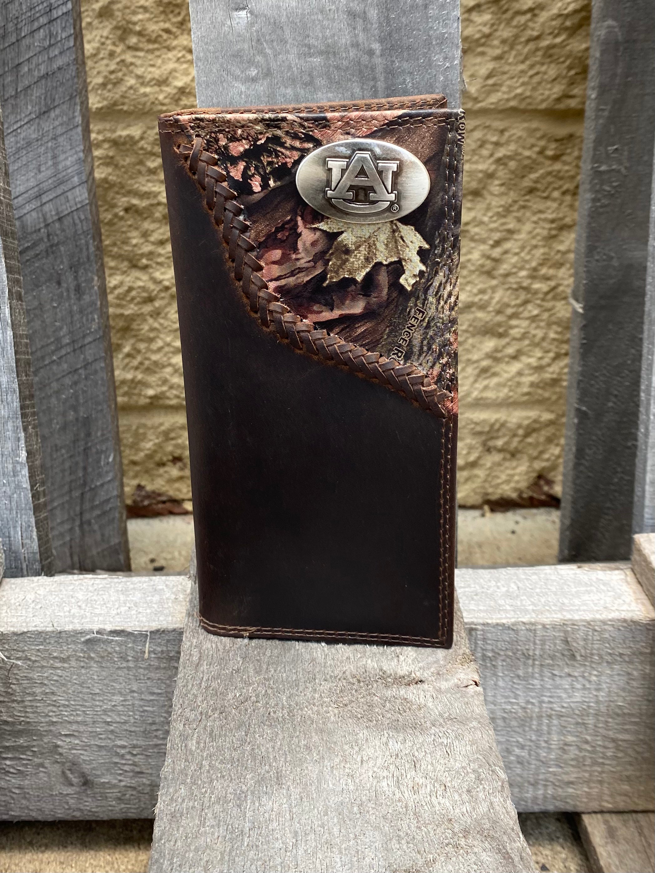 Zep-Pro Auburn University Tigers 1/2 Mossy Oak Camo Leather Tall Wallet front view shows Auburn University logo oval brass concho on top right.
