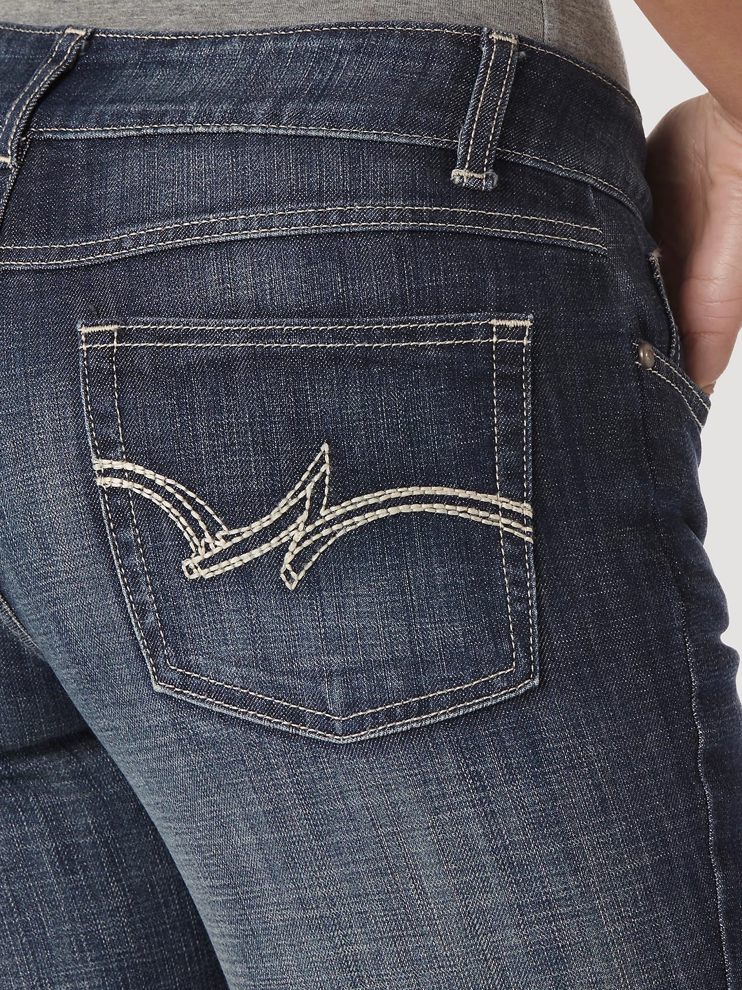 Women's Wrangler Essential Medium Wash Mid-Rise Straight Leg Jean CLOSEOUT. Close up view of right back patch pocket with top stitch detail.