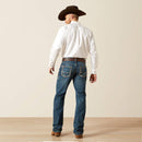 Men's Ariat M4 relaxed fit boot cut jeans in a medium wash. Rear View