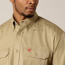 Men's Ariat FR long sleeve work shirt in Khaki. Close up of chest showing Ariat shield logo on left chest pocket. 