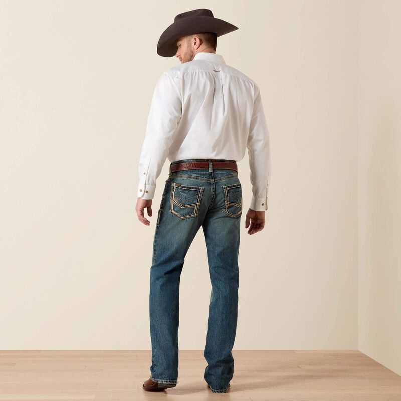 Men's Ariat M5 slim fit straight leg jean in a medium wash. Rear view