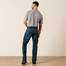 Men's Ariat M4 Rebar relaxed fit boot cut work jeans in a dark wash. Rear View