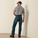 Men's Ariat Rebar M4 relaxed fit boot cut work jeans in a medium wash. Rear View