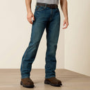 Men's Ariat Rebar M4 relaxed fit boot cut work jeans in a medium wash. Front view