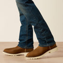 Men's Ariat Rebar straight leg work jeans in a dark wash. Bottom view showing leg opening over boots. 