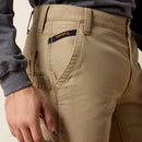Men's Ariat FR Khaki boot cut pants. Close up view of front pockets showing Ariat FR logo tag. 