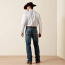 Men's Ariat M4 relaxed fit boot cut jeans in a medium wash. Rear view showing jeans on model.