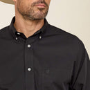 Men's Ariat long sleeve wrinkle free shirt in Black. Close up of left chest pocket showing Ariat logo.